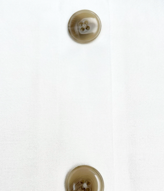 Close-up of white linen weave and horn-effect buttons
