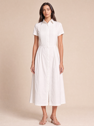 Delphine white cotton shirt-dress, styled campaign image with hand-pressed pintuck bib