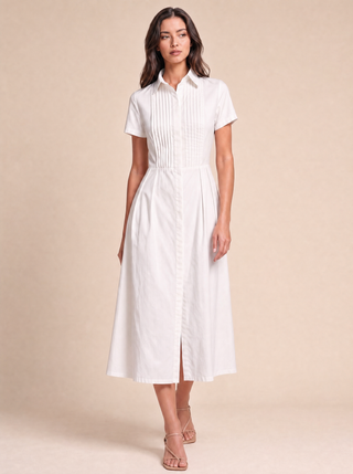 Delphine white cotton shirt-dress, styled campaign image with hand-pressed pintuck bib
