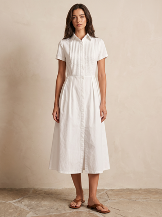 Model wearing the white Delphine pintuck midi shirt-dress, editorial full-length view